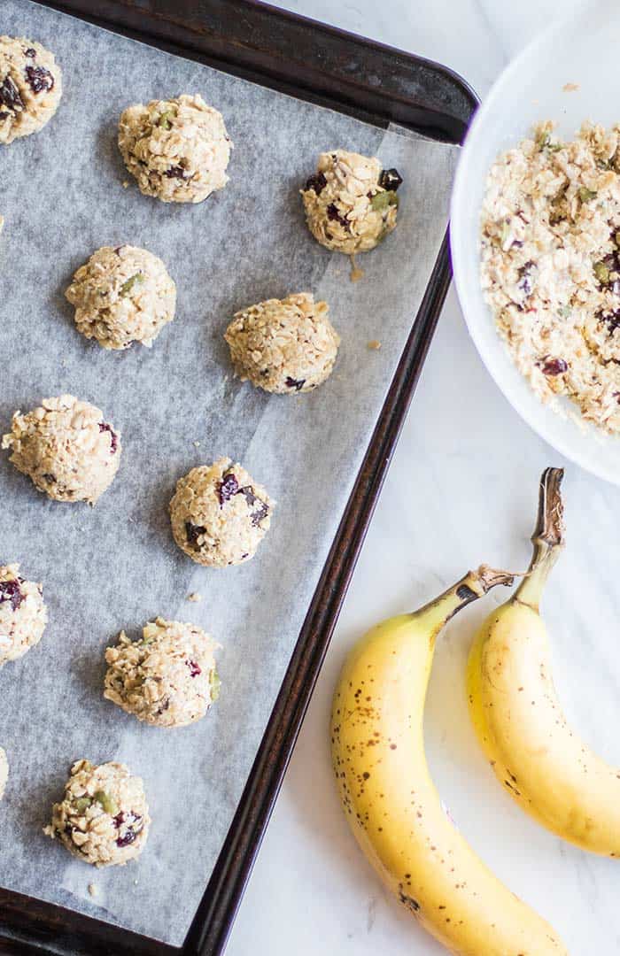 A cookie sheet with healthy gluten free breakfast cookies scooped with a tablespoon.