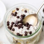 Cookie dough overnights oats shown in a jar with lots of chocolate chips sprinkled on top.