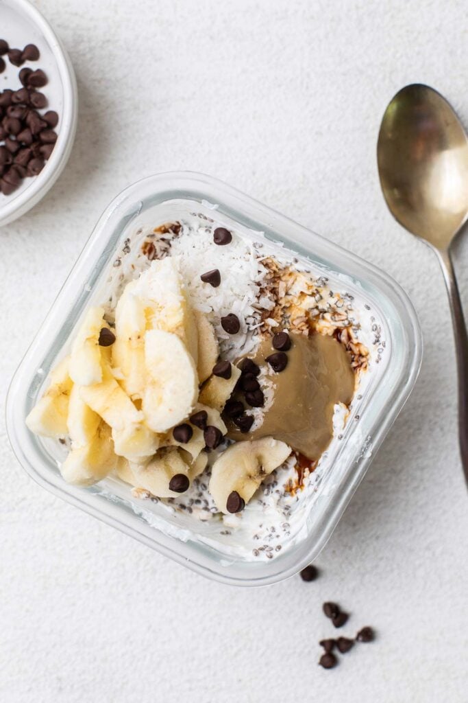 The chia and oat bowl topped with banana, nut butter, vanilla, coconut, and chocolate chips.