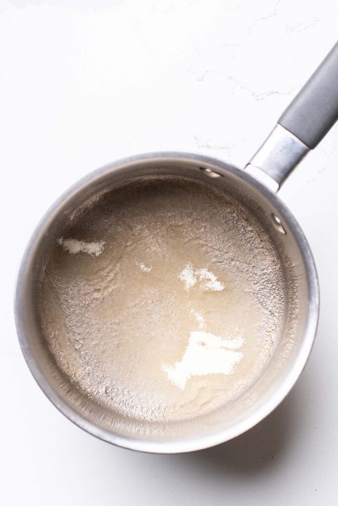 Gelatin and water in a pan allowing the gelatin to bloom.