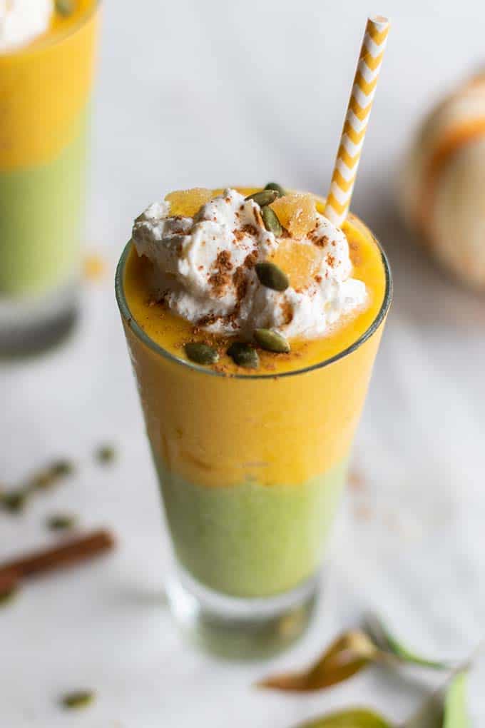 A close up look at a layered green pumpkin pie smoothie.