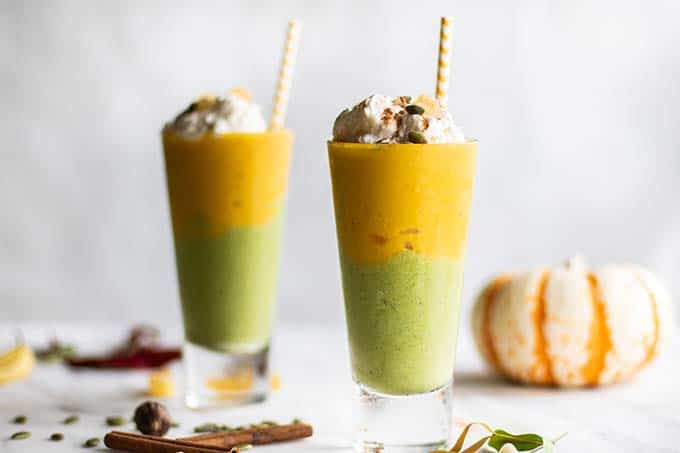 PUmpkin pie smoothies topped with whipped cream and pumpkin seeds.