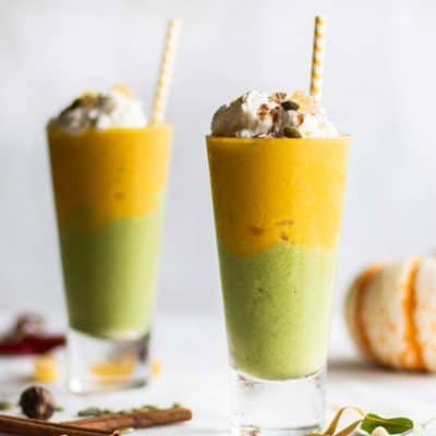 PUmpkin pie smoothies topped with whipped cream and pumpkin seeds.