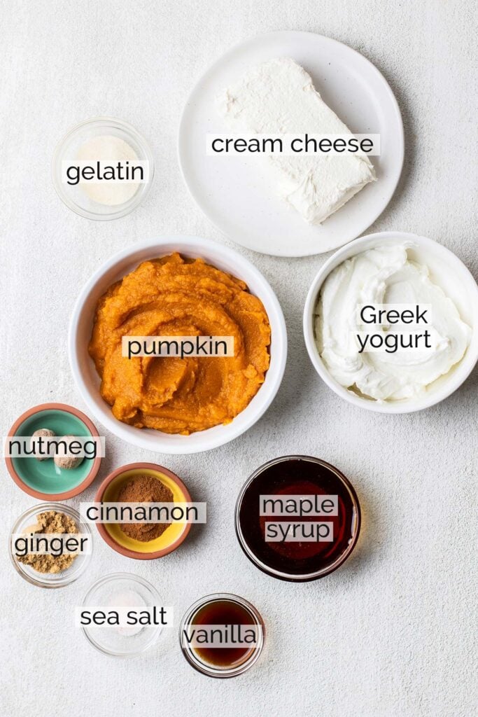 The ingredients needed to make a creamy Greek yogurt pumpkin cheesecake filling.