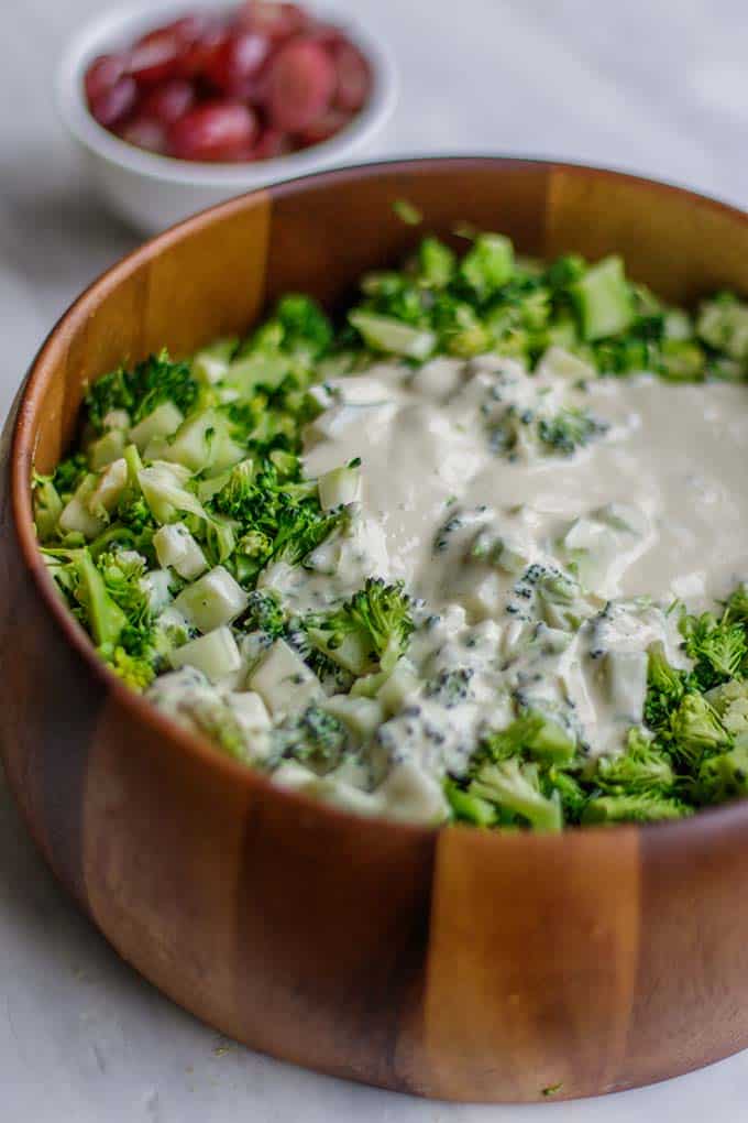 A bowl of broccoli with a creamy tahini dressing.
