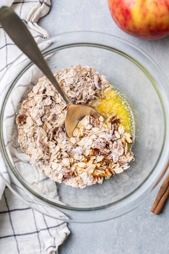 Butter and maple syrup added to the bowl with the dry ingredients.