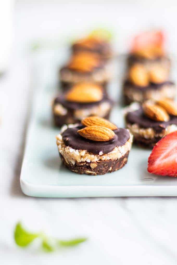 A plate with lots of healthy no bake almond joy cookies.