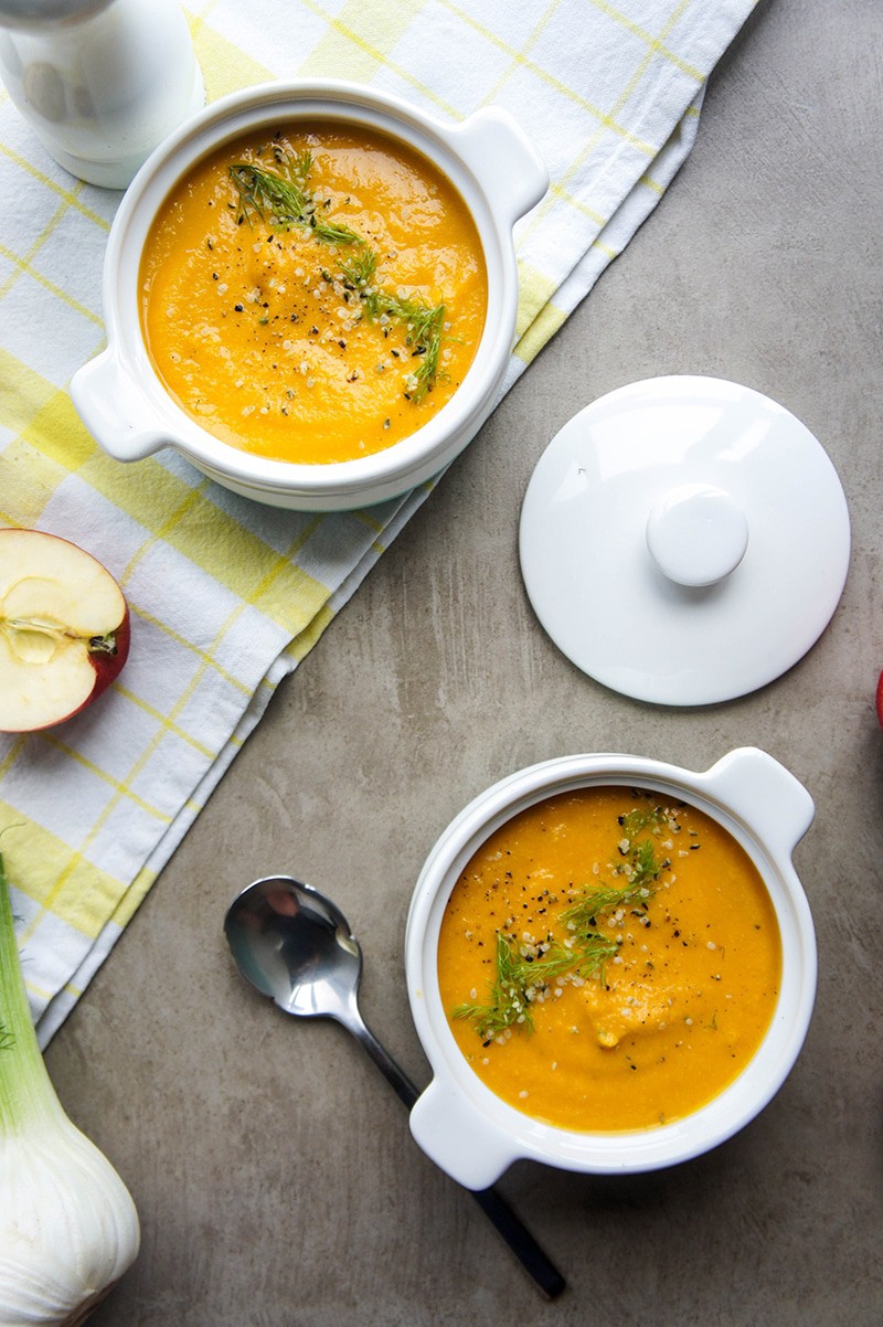 Two bowls of carrot apple fennel soup.