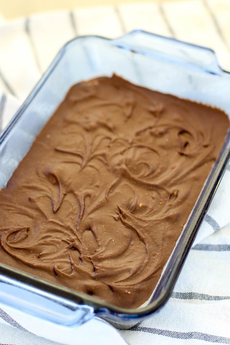 A glass pan filled with a chocolately fudge, set and ready to slice.