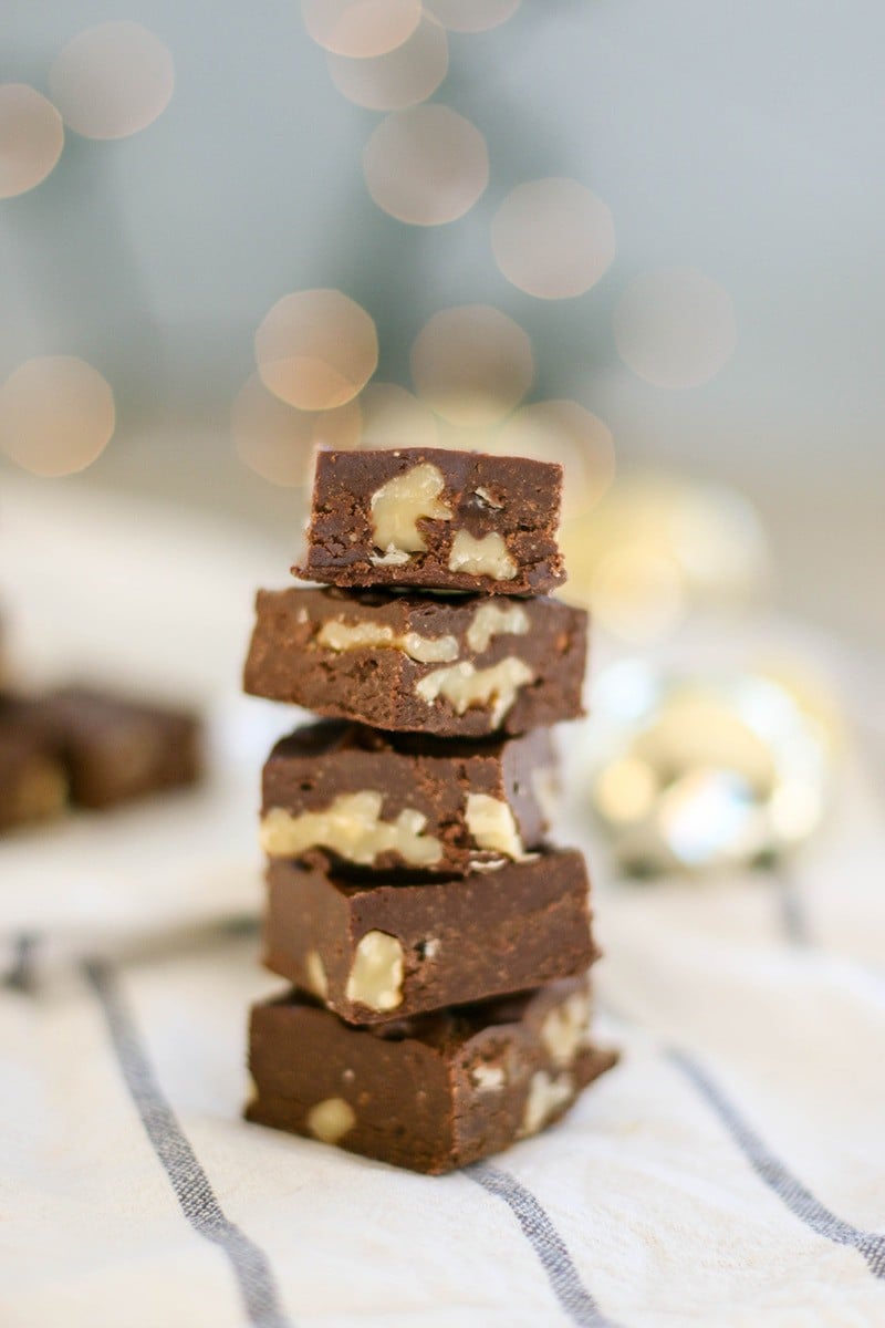 A stack of paleo fudge squares studded with walnuts.
