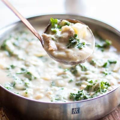 A shot looking down at a creamy bowl of zuppa toscana.