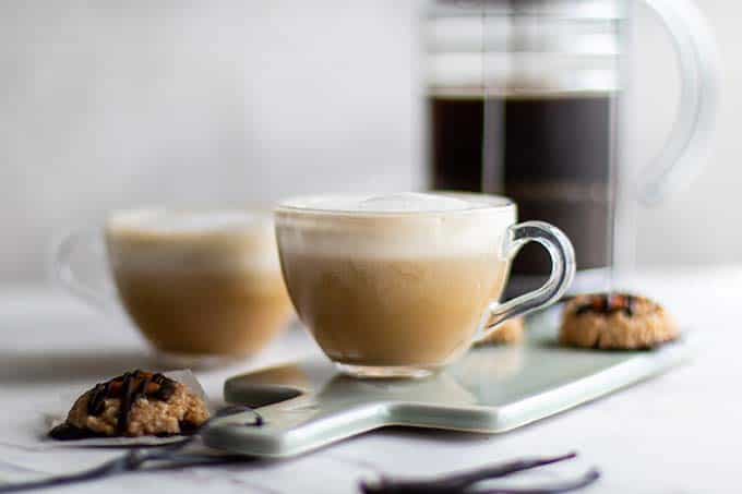 Two clear mugs with a vegan almond latte.