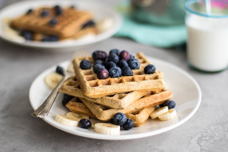 Gluten free waffles topped with a low sugar blueberry syrup.