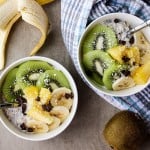A healthy bowl of overnight oats with greek yogurt and chia seeds topped with fruit.