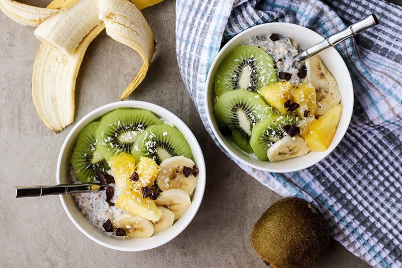 A healthy bowl of overnight oats with greek yogurt and chia seeds topped with fruit.
