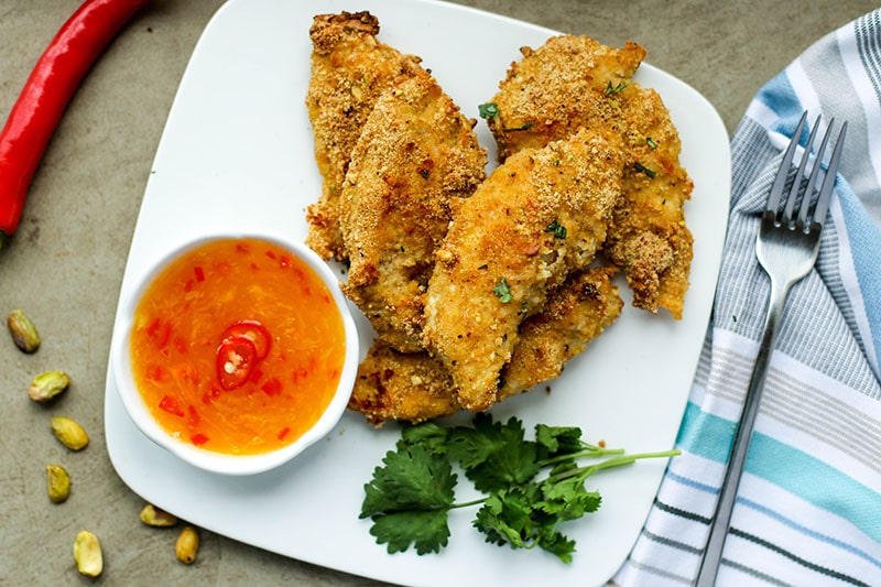 Pistachio Crusted Chicken / These baked chicken fingers have grown up nutty flavor, and bake to golden perfection! A new family favorite, for sure!