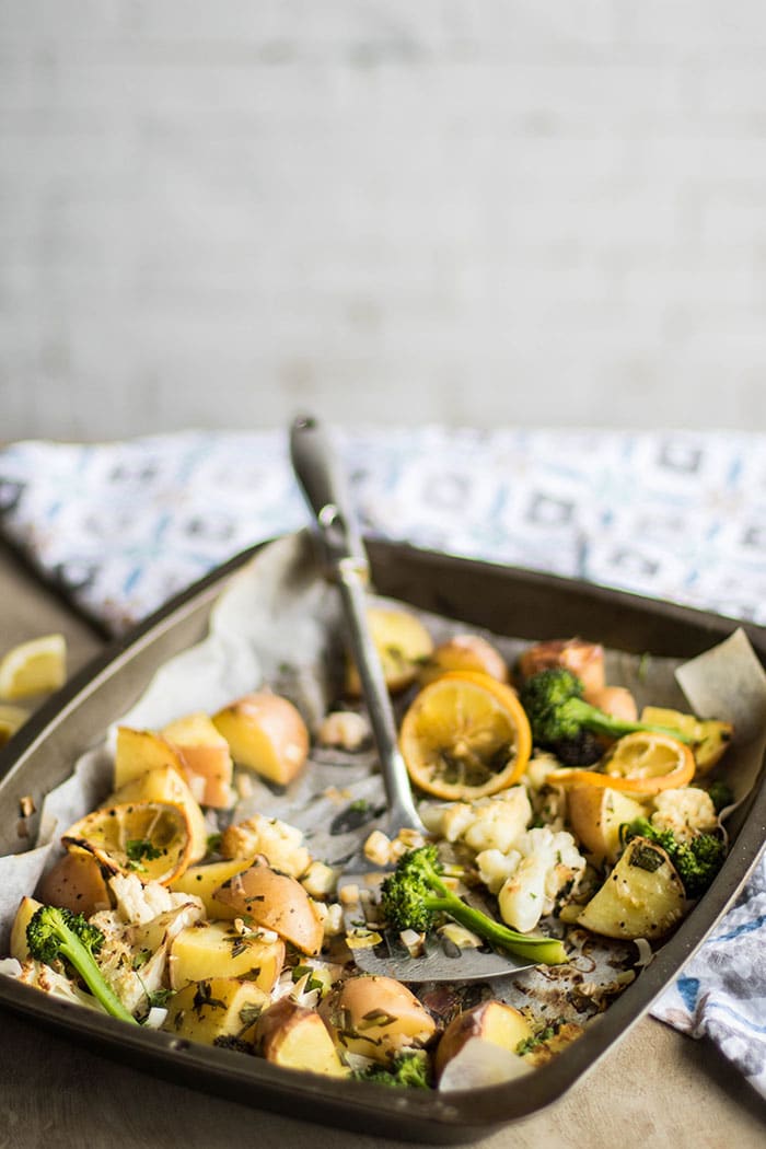 A roasting pan with veggies being scooped out.