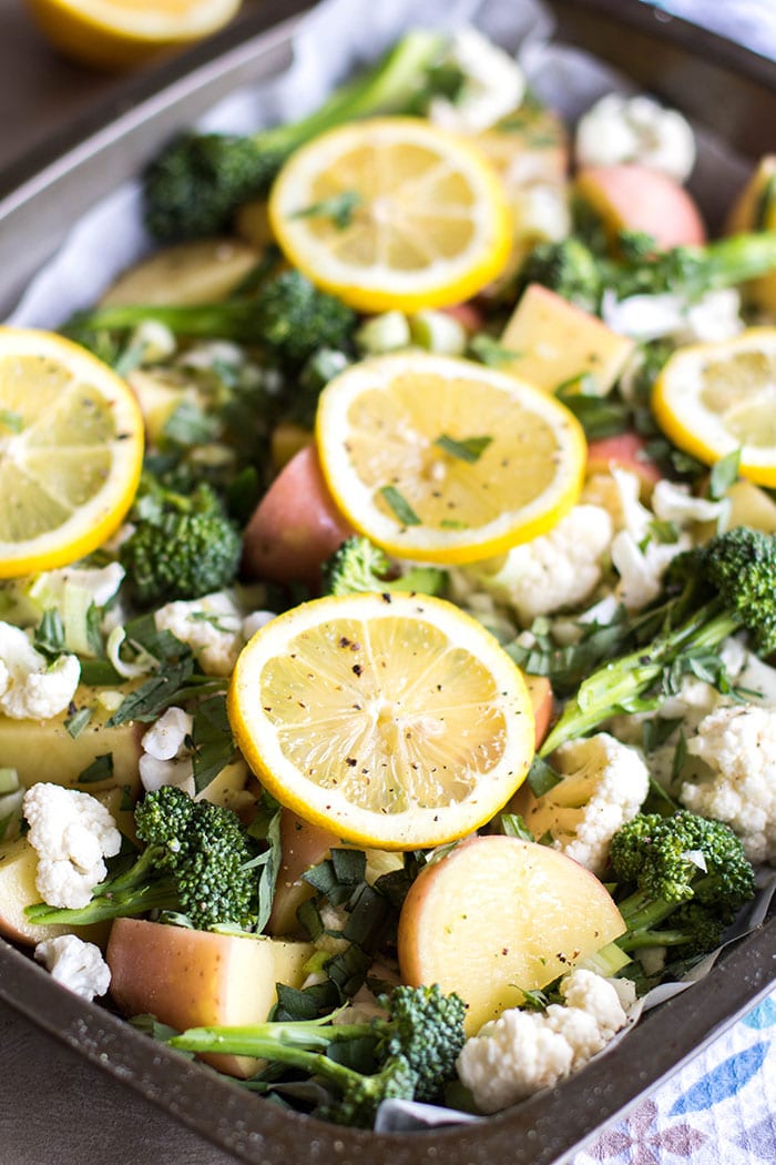 A baking tray will with raw vegetables ready to be baked.