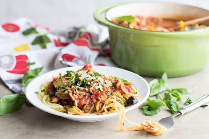 A plate of zoodles topped with chicken vegetable spaghetti sauce, a great low carb dinner.