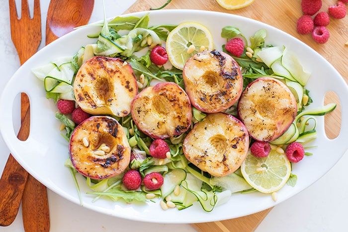 Serrano Honey Grilled Peaches / This simple summer salad is made with sweet grilled peaches and topped with a sweet and spicy vinaigrette.