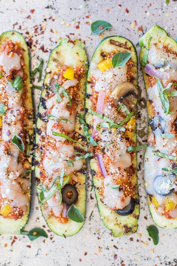 Grilled Quinoa Pizza Zucchini Boats / Have fun with a vegetarian entree on the BBQ this summer. Zucchini is stuffed with a 1-pan quinoa pizza recipe.