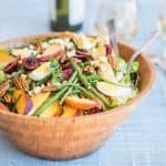 Mid Summer Dream Salad - crisp greens are topped with green beans, corn, cherries and peaches.