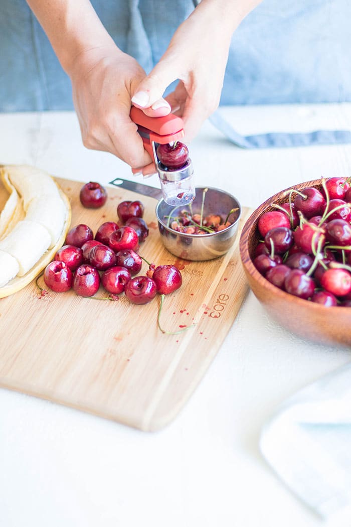 Michelle pitting cherries.