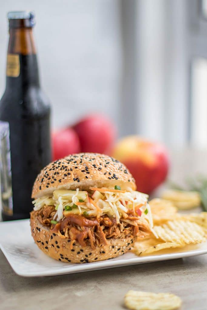 Sweet Onion Apple BBQ Pulled Chicken Sandwich / This delicious sandwich is made with a low sugar apple BBQ sauce, and topped with a tangy apple slaw.