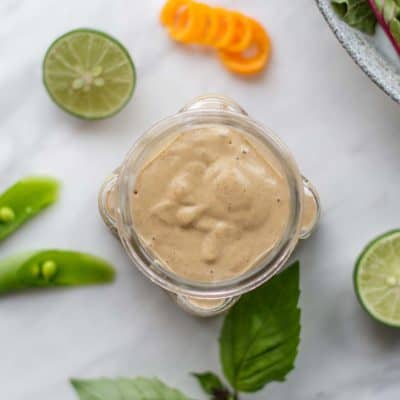 A top view of a jar filled with Spicy Thai Almond Sauce.