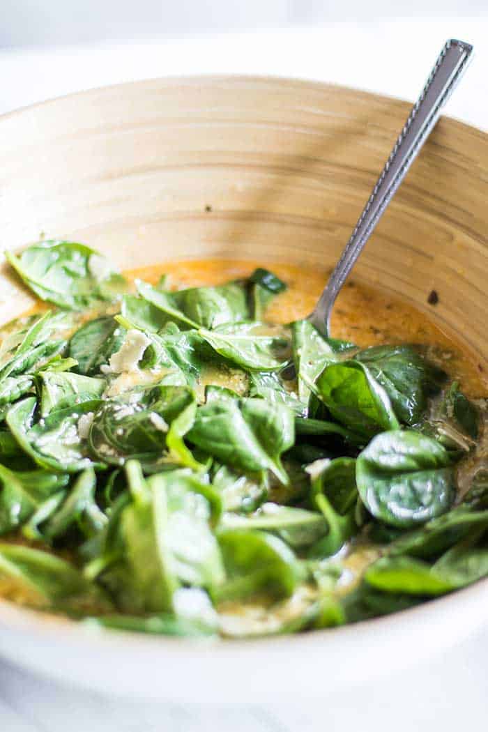A bowl full of egg and spinach mixture.