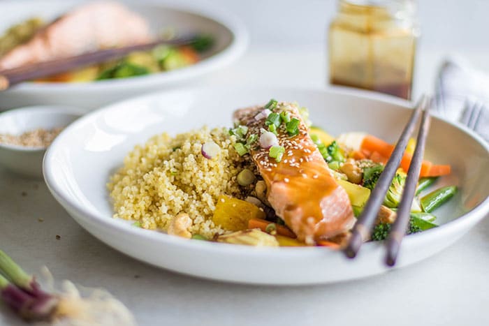 Salmon Teriyaki Recipe / These delicious bowls are loaded with millet, veggies, poached salmon, pineapple and cashews, and drizzled with a flavorful teriyaki sauce.