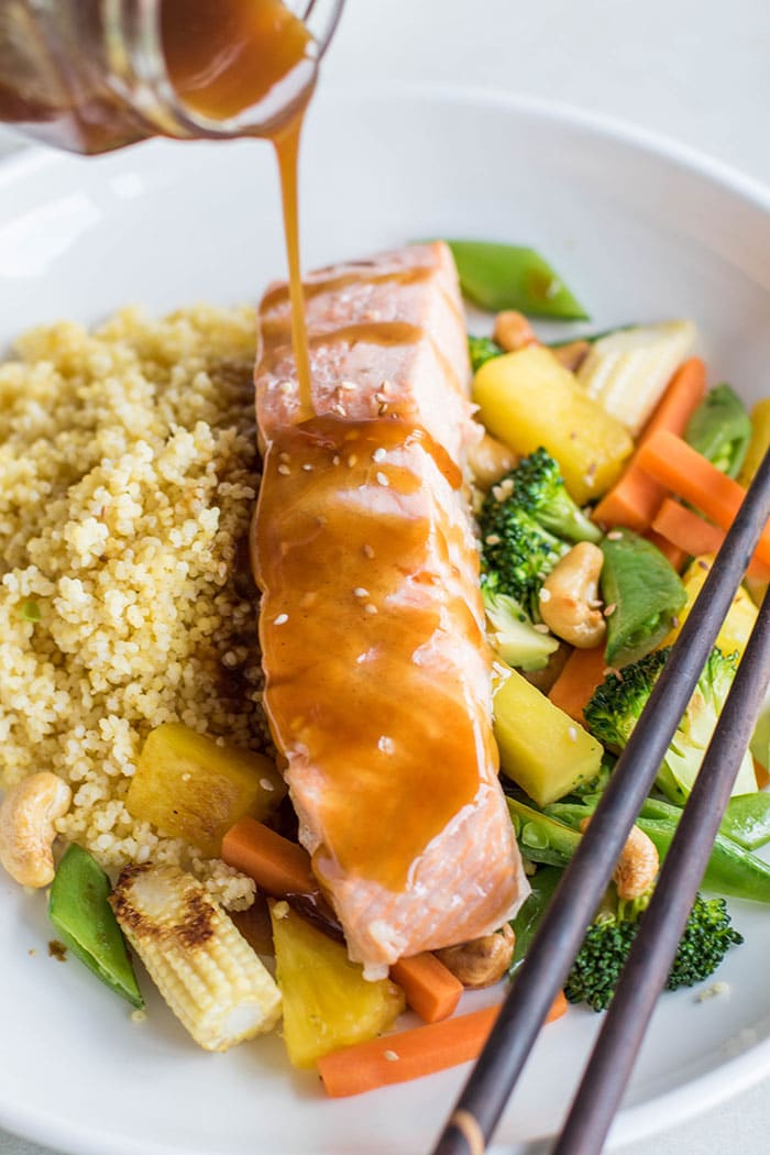 Soy free teriyaki sauce being drizzled on top of a piece of poached salmon.