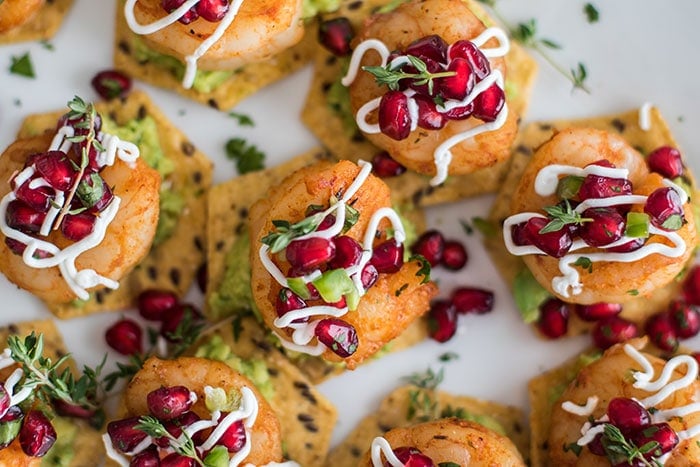 Shrimp Tostadas with Pomegranate Guacamole / The perfect healthy party appetizer! Blackened shrimp, guacamole, and a tangy pomegranate salsa.