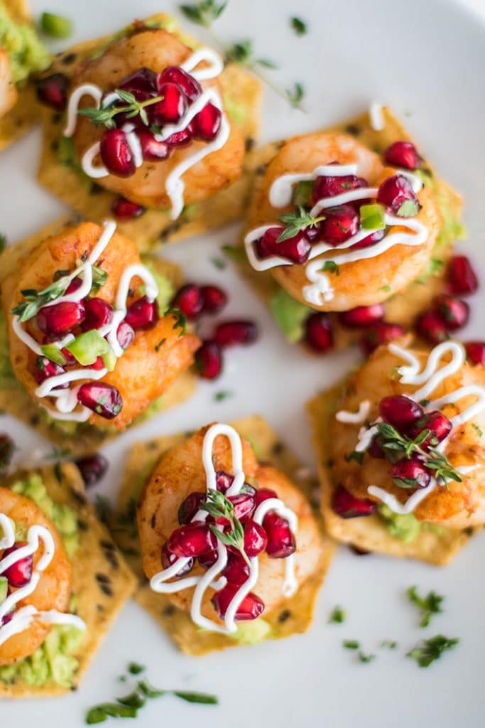 Mini Shrimp Tostadas / The perfect healthy party appetizer! Blackened shrimp, guacamole, and a tangy pomegranate salsa.