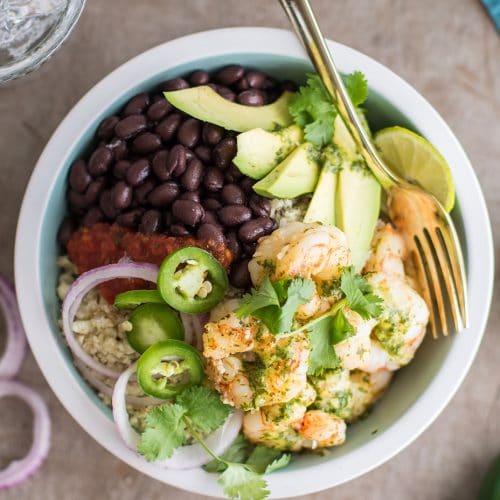 A top view of a low carb cilantro lime shrimp burrito bowl on cauliflower rice.