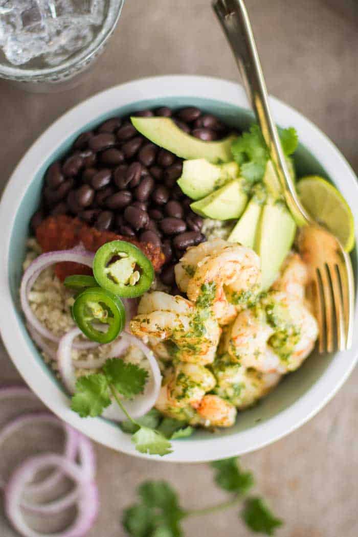 A loaded low carb burrito bowl, topped with cilantro lime marinated shrimp.