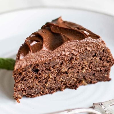 A piece of chocolate cake with a thick layer of healthy chocolate frosting.