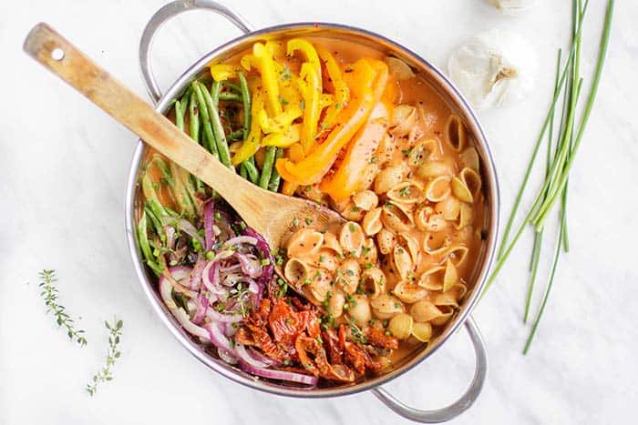 A vegan one pot pasta smothered in creamy tomato pasta sauce with lots of colorful veggies.