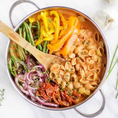 A pot on a counter top filled with this vegan one pot pasta recipe.