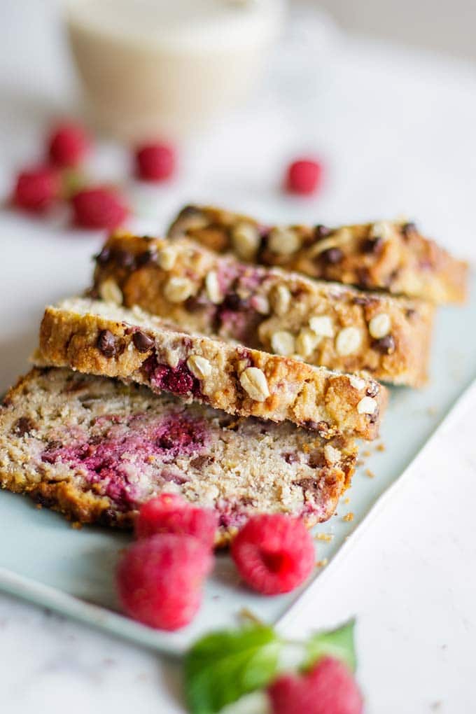 Thick cut slices of gluten free banana and raspberry bread on a blue plate. 