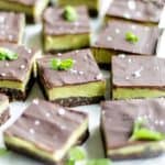 Raw peppermint vegan brownies, shown cut into little squares. A healthy no bake brownie.