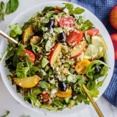 A quinoa salad with feta, nectarines, olives, tomatoes and arugula.