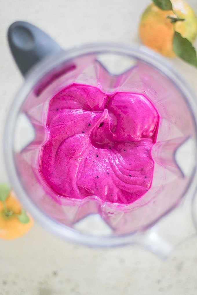 A pink bubblegum ice cream treat made raw and vegan with frozen fruit in a blender.