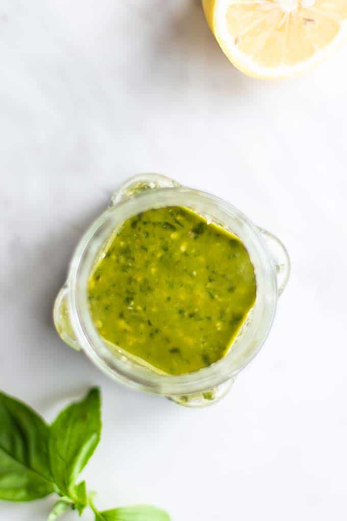 A top view looking down into a jar of easy pesto vinaigrette.