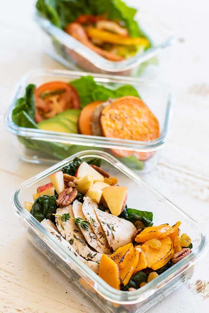 3 Meal prep boxes with a kale salad, sausage lettuce wrap, and turkey burger, all great whole30 lunch options.