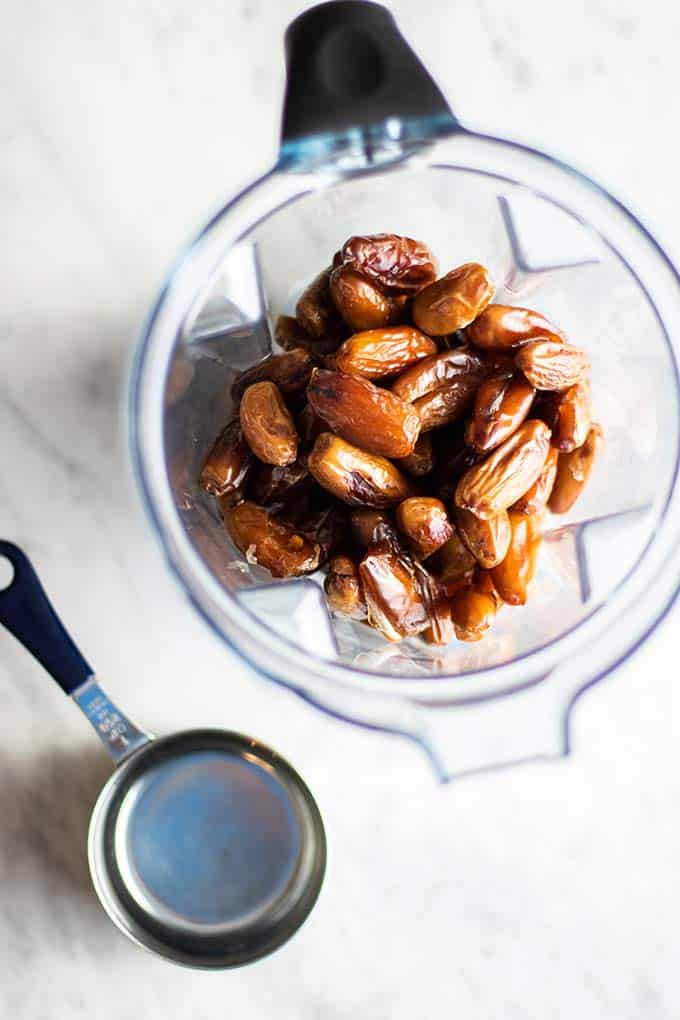 Dates in a blender with a cup of hot water.