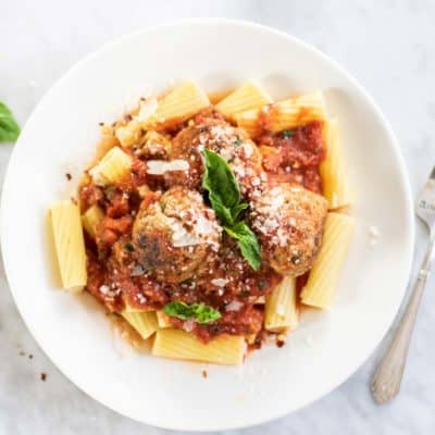 Gluten free turkey meatballs served on pasta.