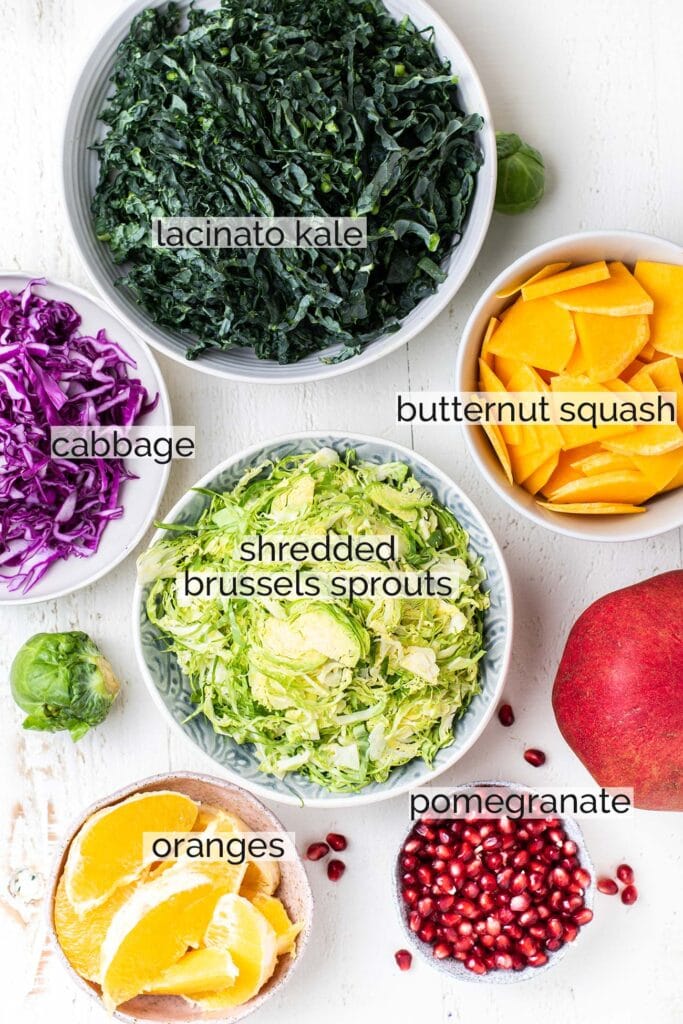 The ingredients needed to make a healthy kale salad shown with labels.