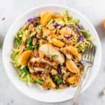 A close up of a Whole30 Chinese Chicken salad with cabbage, oranges, carrots, and almonds.