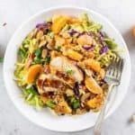 A close up of a Whole30 Chinese Chicken salad with cabbage, oranges, carrots, and almonds.